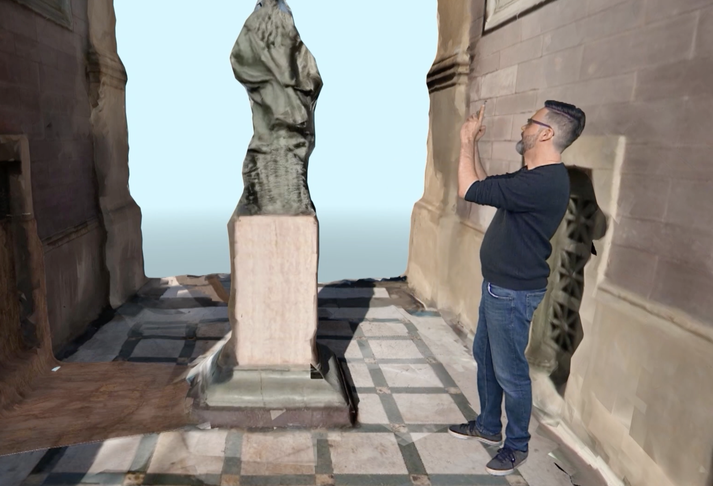 A presenter walks around a 3D model.
